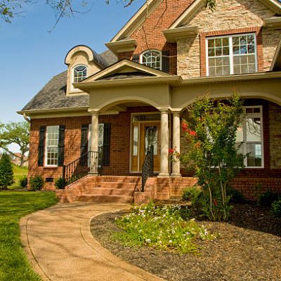 A single family home in Nashville, Tennessee on a bright summer day with a clear blue sky.